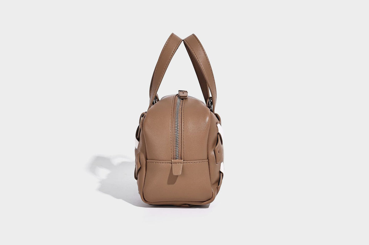 Small structured satchel bag with two-tone woven front panel, dual top handles, and detachable crossbody strap in tan brown