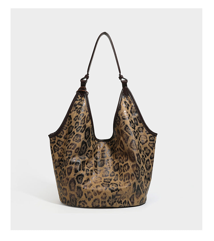 Large slouchy leopard-print shoulder tote bag with glossy tan-and-brown finish, dark brown leather-look trim, single