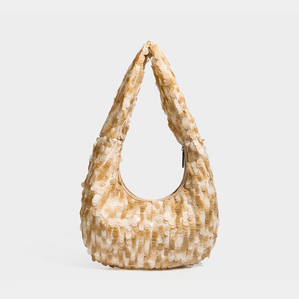 Slouchy crescent hobo shoulder bag covered in overlapping reflective sequin discs with a single integrated strap and top-zip