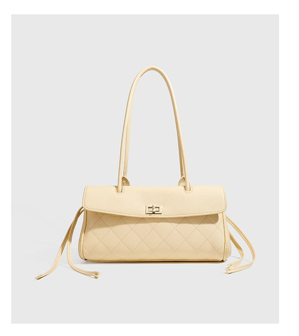 Structured black diamond-quilted shoulder bag with gold-tone turn-lock flap closure and dual round shoulder straps, detail