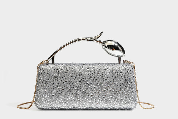 rectangular hard-case rhinestone evening clutch with sculptural gold-tone branch-and-bud top handle and detachable chain