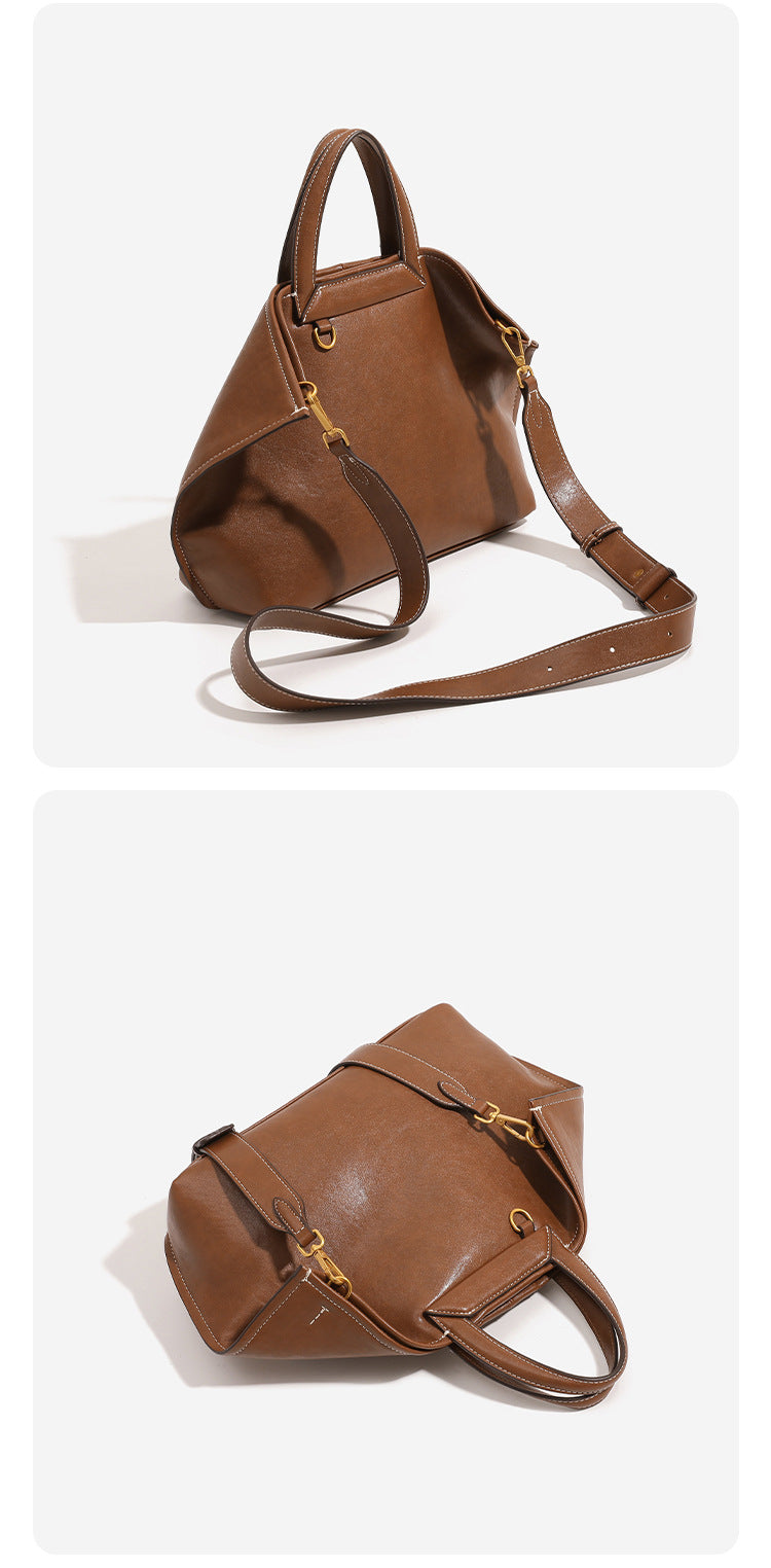 Structured cognac brown leather-look tote bag with fold-ear side panels, top handles, gold-tone hardware, and detachable