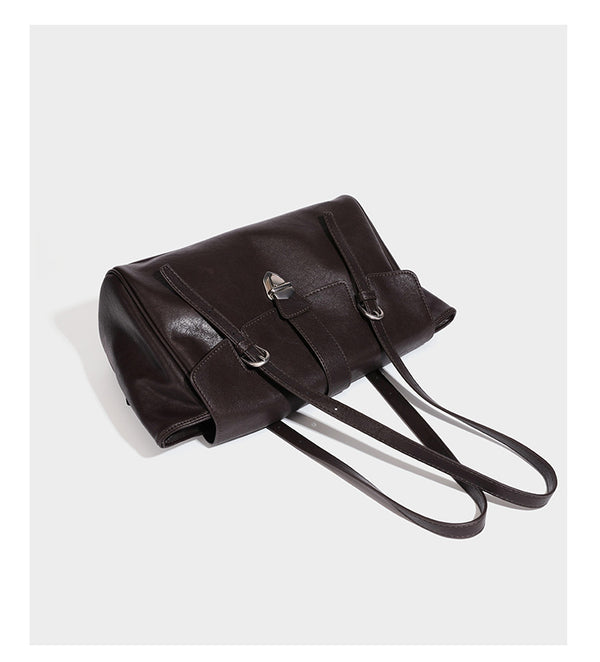 Large structured vintage-style tote bag with flap-front turn-lock closure, twin buckle straps, and double shoulder handles