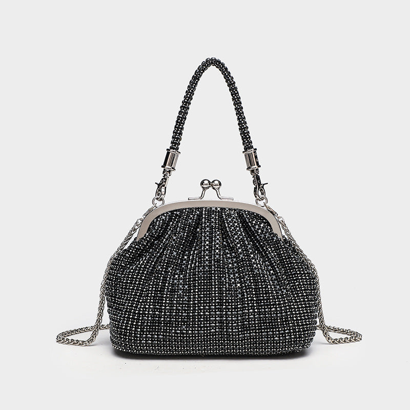 Compact all-over rhinestone kiss-lock evening bag with silver-tone metal frame, rhinestone top handle, and detachable chain