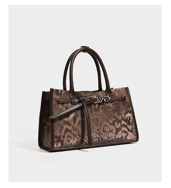 Structured leopard-print tote bag with glossy satin-like finish, dual rounded top handles, silver buckle-and-ring front