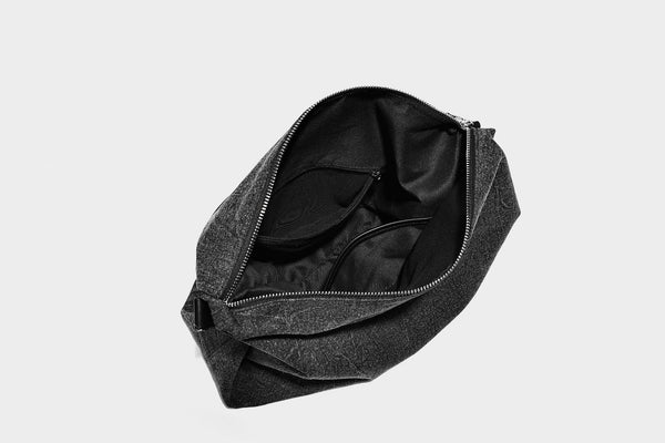 Charcoal denim-textured slouchy hobo bag with zip-top closure, silver-tone hardware, and adjustable leather-look crossbody