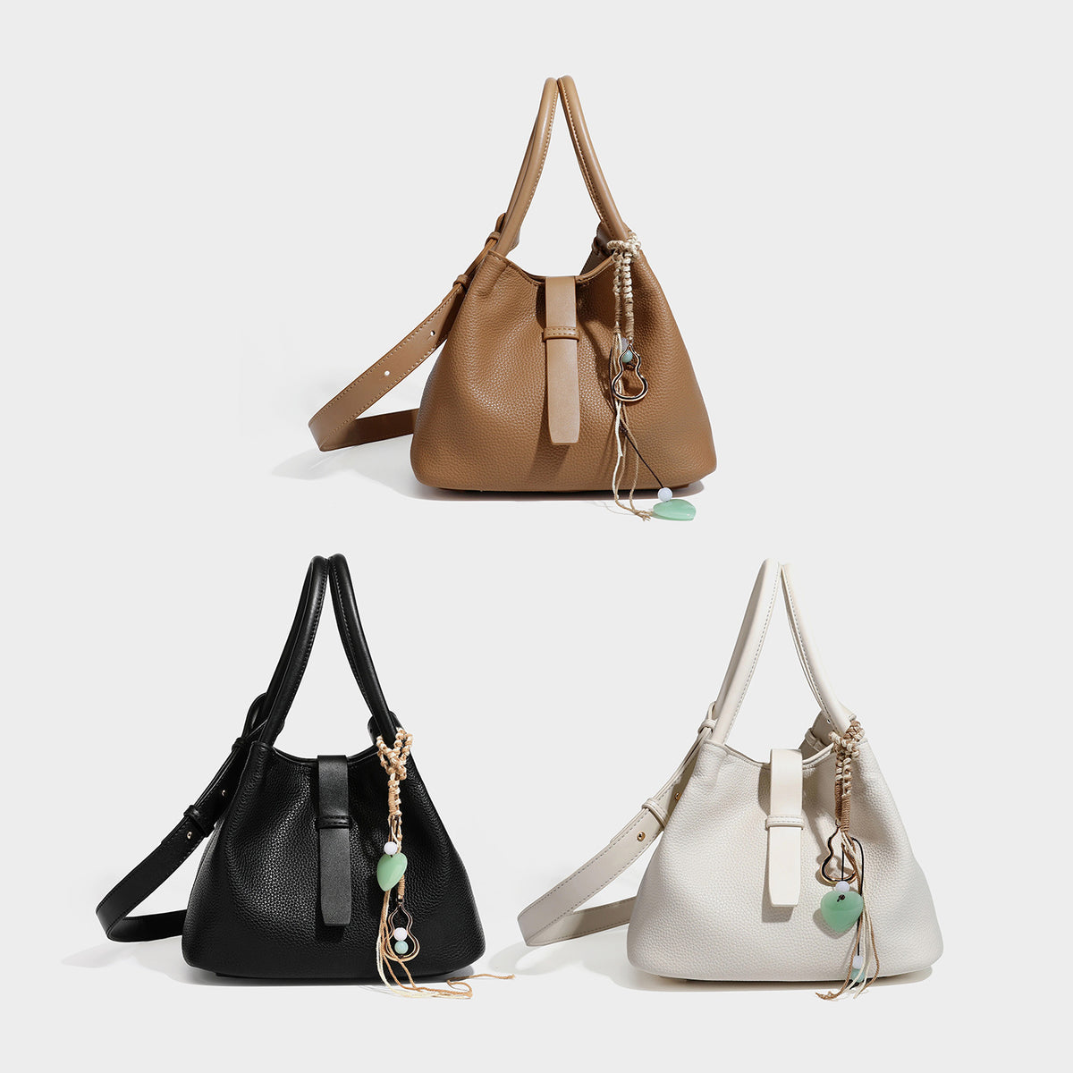 Pebbled leather-look bucket tote bag with rolled double handles, drawstring closure, braided cord charm, and detachable