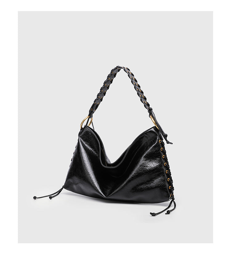 Large slouchy hobo shoulder bag with braided top handle, gold-tone O-ring hardware, and lace-up side cord detailing in