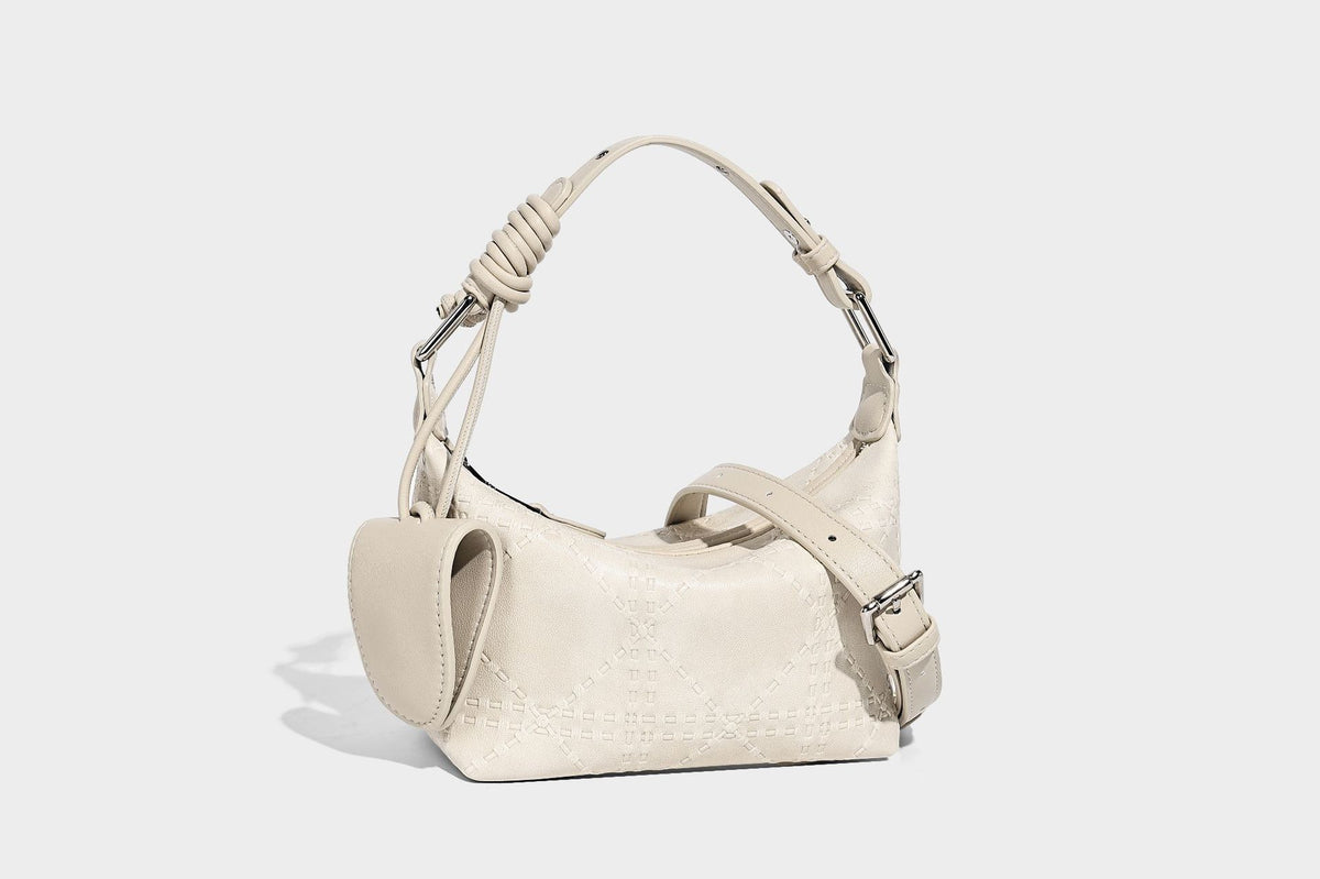 Small embossed half-moon shoulder bag with top zipper, detachable front pouch, and adjustable slim strap, detail view 13