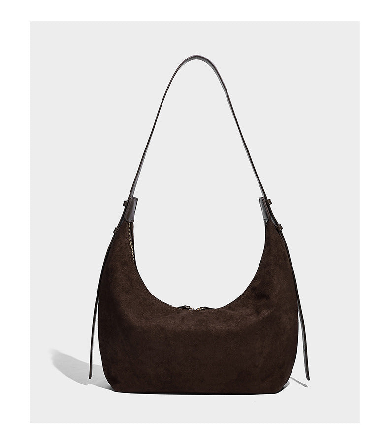 Slouchy crescent hobo shoulder bag in dark chocolate matte suede-look finish with adjustable strap and twin-pull top zip
