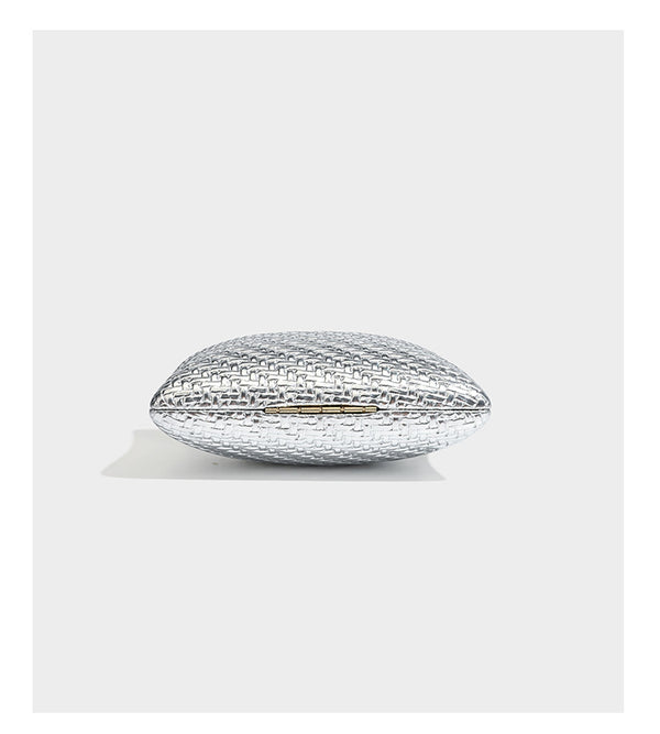Small structured rectangular metallic woven-texture clutch bag with jeweled knob clasp and gold-tone chain strap, detail view