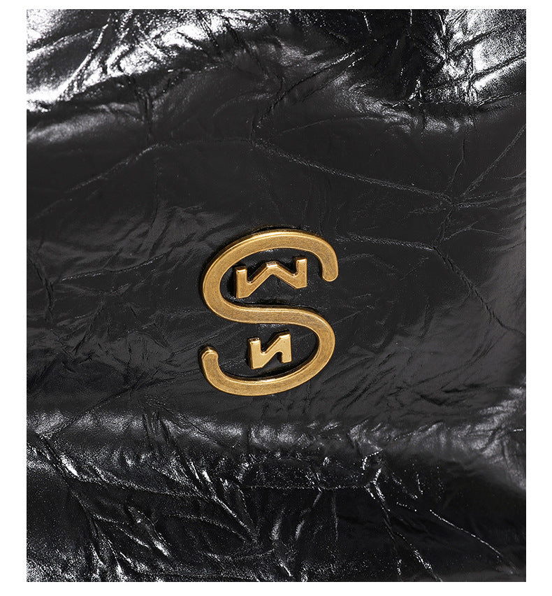 Glossy crinkled hobo shoulder bag with gold-tone logo hardware and adjustable strap, detail view 9
