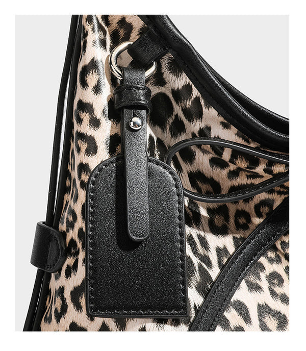Slouchy leopard print shoulder hobo bag with black leather-look trim, tie-top closure, and single long strap, detail view 21