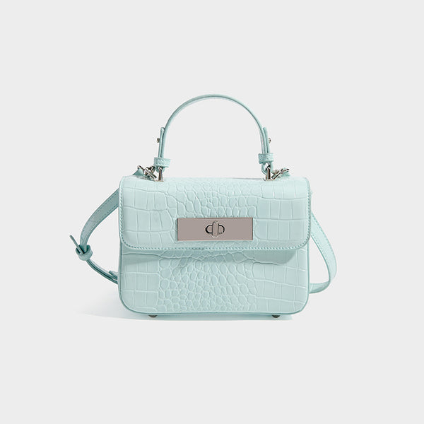 Small structured rectangular satchel with glossy crocodile-embossed finish, arched top handle, front flap, and silver-tone