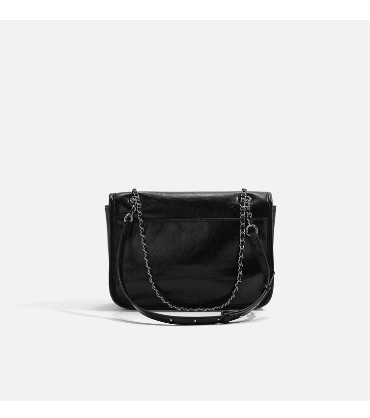 Structured glossy leather-look flap crossbody satchel with woven chain-and-leather shoulder strap, detail view 12
