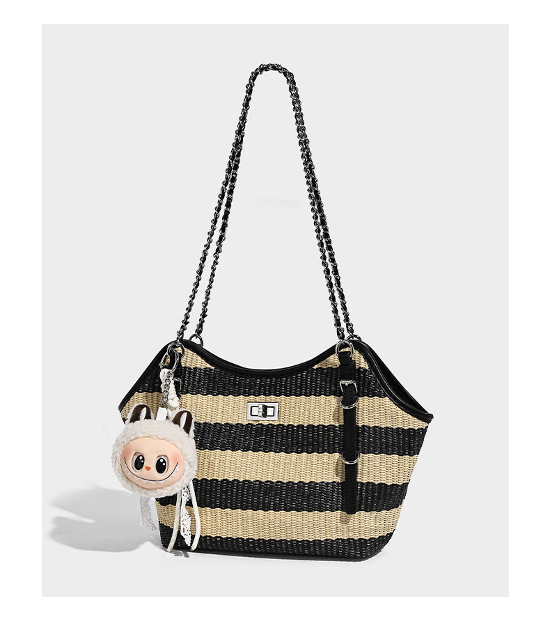 Black and natural striped woven tote bag with chain shoulder strap and silver-tone turn-lock hardware, detail view 7