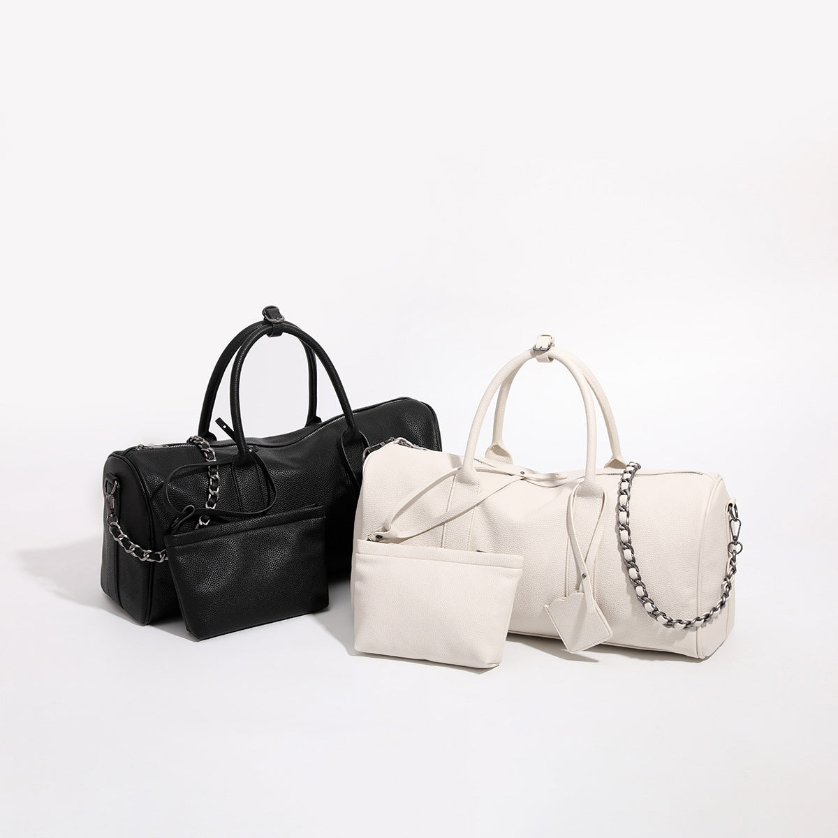 Large cream white pebbled leather-look barrel travel bag with twin top handles, chunky chain shoulder strap, front zip, front