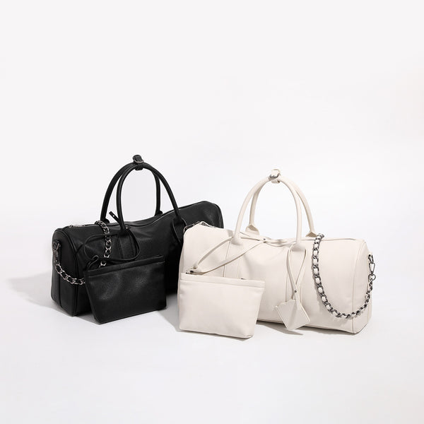 Large cream white pebbled leather-look barrel travel bag with twin top handles, chunky chain shoulder strap, front zip, front