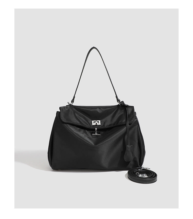 Structured black leather-look flap satchel bag with silver turn-lock hardware and top handle, detail view 26