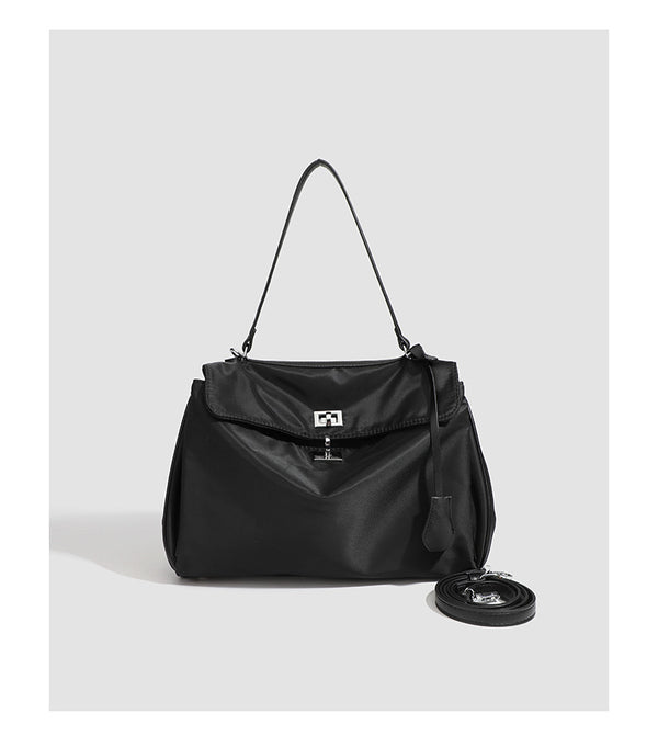 Structured black leather-look flap satchel bag with silver turn-lock hardware and top handle, detail view 26