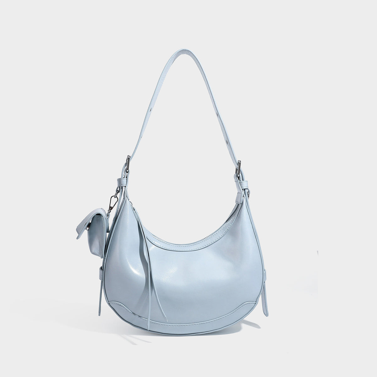 Glossy leather-look crescent hobo shoulder bag with dark contrast trim, silver-tone hardware, and attached mini flap pouch