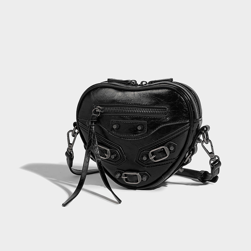 Mini heart-shaped crossbody bag with glossy crinkled finish and moto buckle hardware, detail view 19