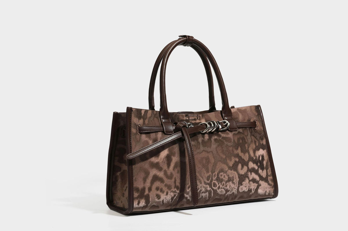 Structured leopard-print tote bag with glossy satin-like finish, dual rounded top handles, silver buckle-and-ring front