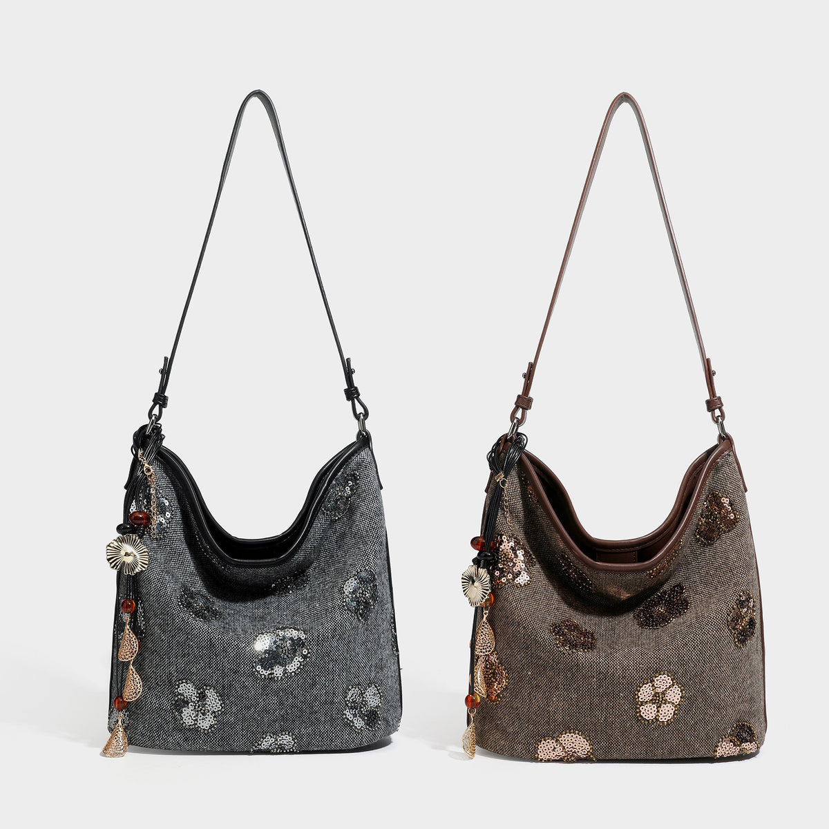 Slouchy hobo shoulder bag in charcoal woven fabric with silver sequin floral embroidery, black leather-look trim, and long
