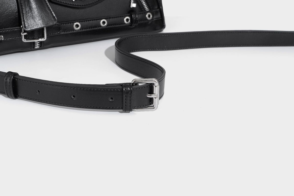 Structured black leather-look satchel bag with silver padlock hardware, front zip pockets, key charms, and top handles