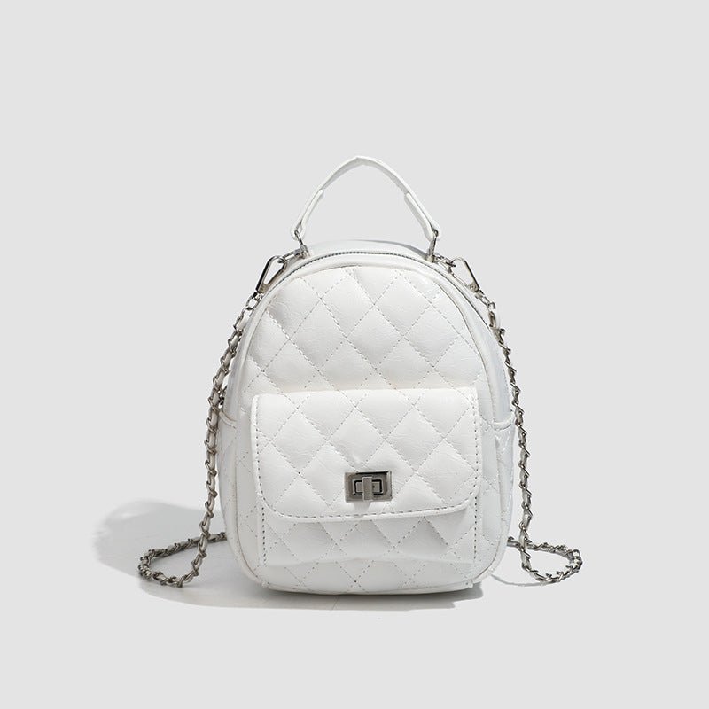 Quilted leather-look backpack purse with chain strap and turn-lock front pocket, detail view 11