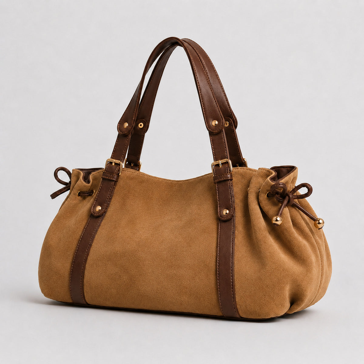 Soft suede-texture shoulder bag in brown with drawstring sides, leather-look vertical straps, gold-tone buckle hardware, and