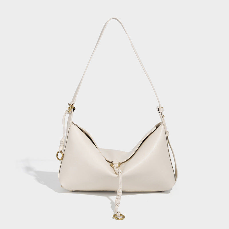 Slouchy brown leather-look shoulder bag with knotted drawcord tie closure, gold-tone ring hardware, and long adjustable