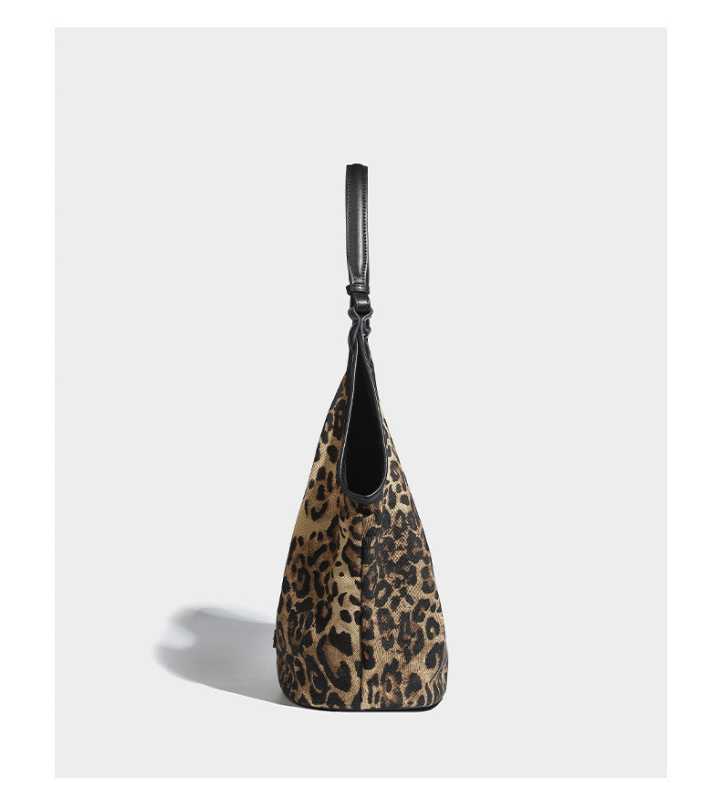 Slouchy brown leopard jacquard hobo tote bag with black leather-look trim and single shoulder strap, shown with black, detail