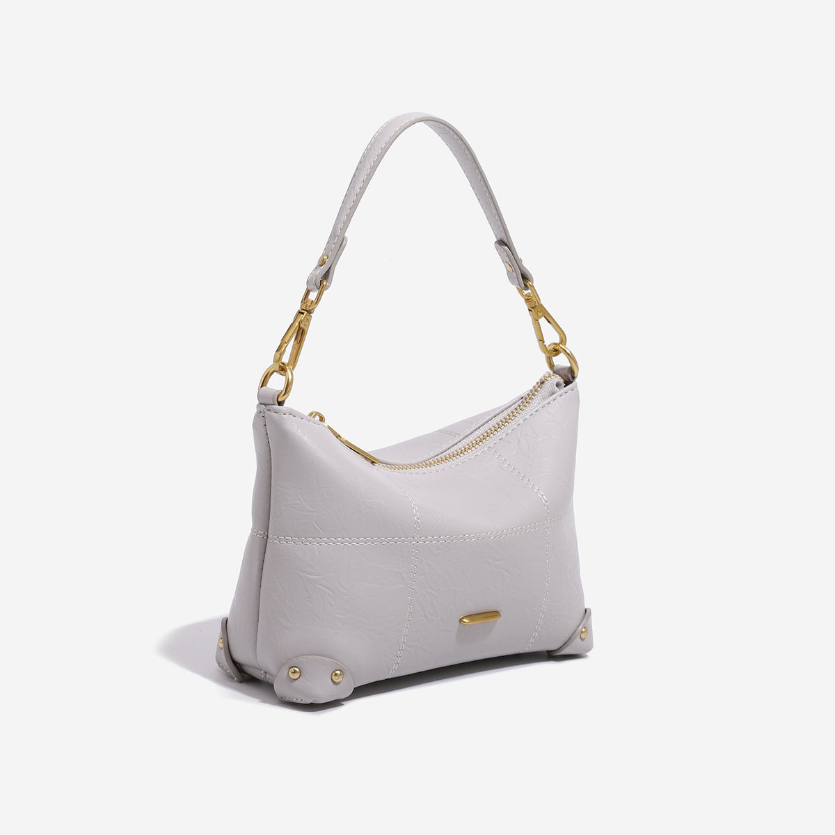 Small soft-structured shoulder bag with curved zip closure, stitched panel detailing, and gold-tone hardware, detail view 3