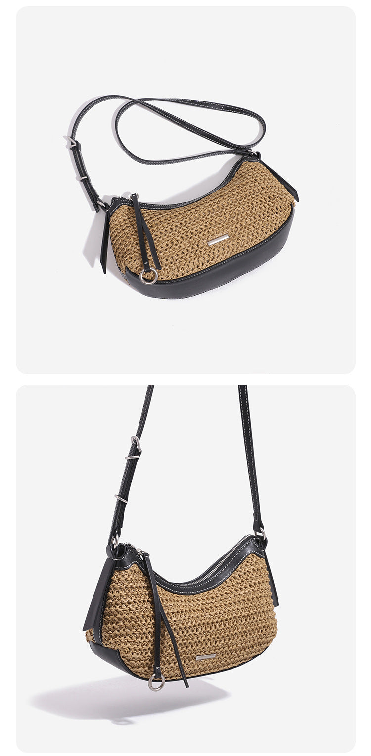 Tan woven straw half-moon shoulder bag with black leather-look trim, zip closure, tassel pull, and adjustable crossbody