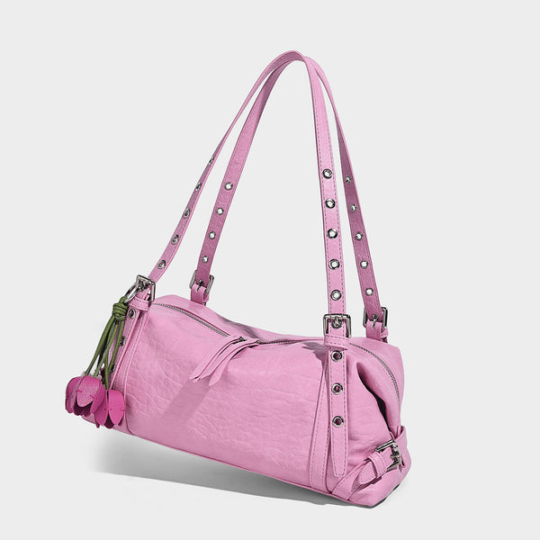Pale yellow leather-look barrel bag with silver grommet-studded shoulder straps, top zip closure, and pink tulip floral