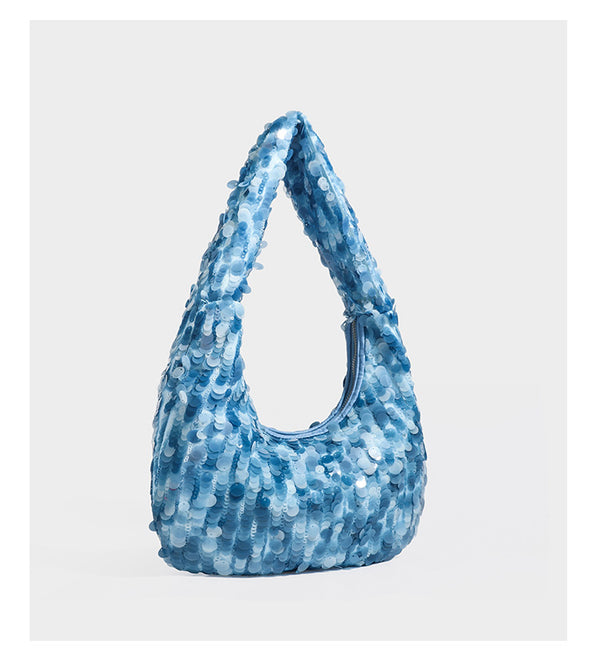 Slouchy crescent hobo shoulder bag covered in overlapping reflective sequin discs with a single integrated strap and top-zip