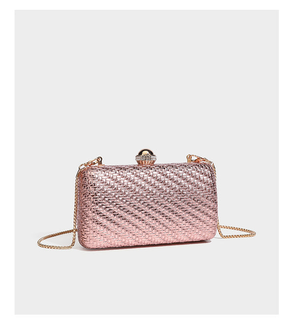 Small structured metallic woven-texture box clutch bag with jeweled kiss-lock dome clasp and slim gold chain strap, detail