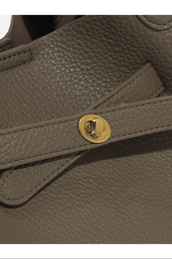 Pebbled trapezoid tote bag with gold turn-lock strap detail and matching snap pouch, detail view 7