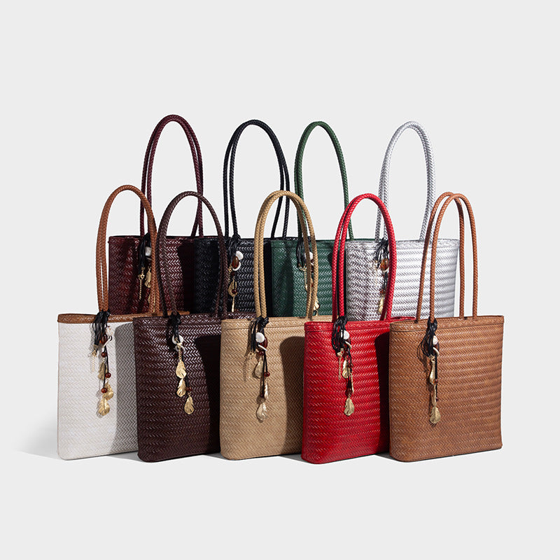 Structured woven herringbone tote bag with braided double shoulder handles in tan brown, shown with matching drawstring