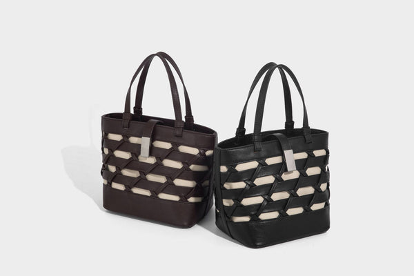 Structured woven lattice tote bag with cream lining, dual top handles, detachable crossbody strap, and silver-tone hardware