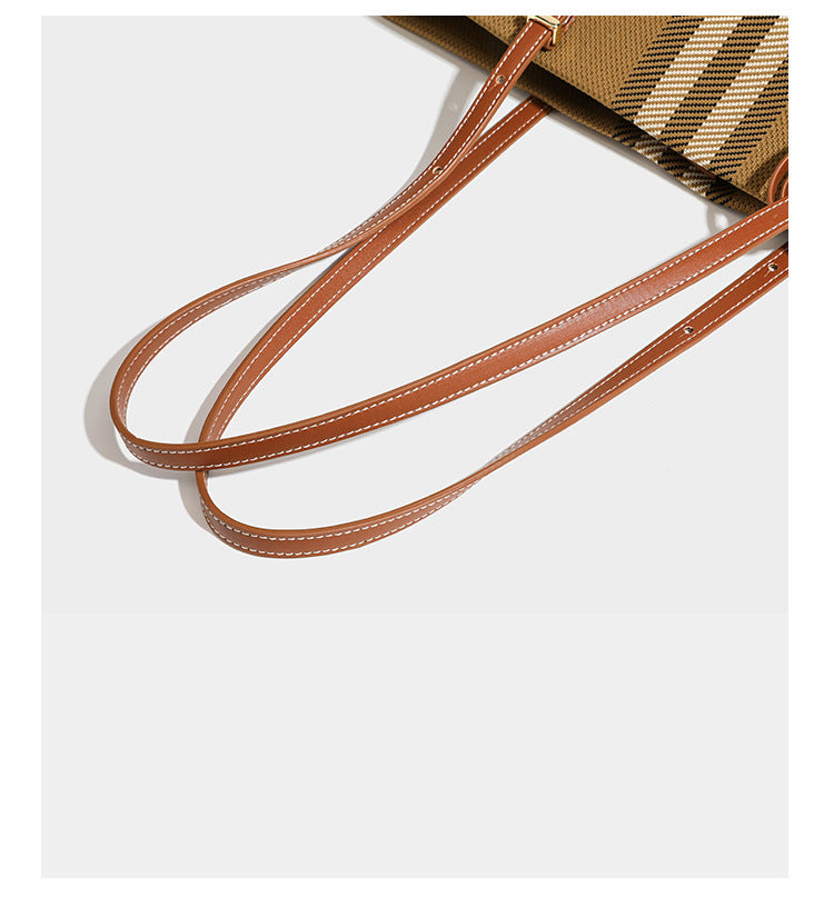Large structured plaid check tote bag with smooth tan leather-look shoulder straps, attached front zip pouch, and gold-tone