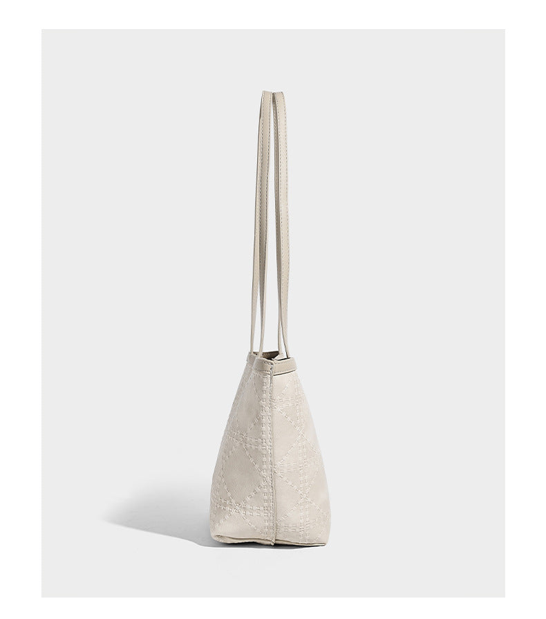 Quilted diamond-pattern tote bag with attached front zip pouch and long shoulder straps, detail view 9