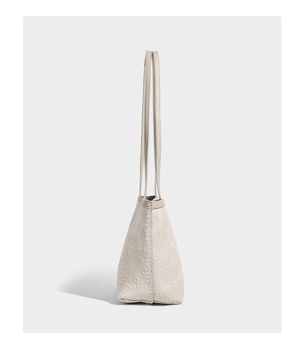 Quilted diamond-pattern tote bag with attached front zip pouch and long shoulder straps, detail view 9