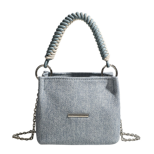 Small structured trapezoid mini bag with coiled rope top handle and silver-tone chain strap in textured fabric, detail view 5