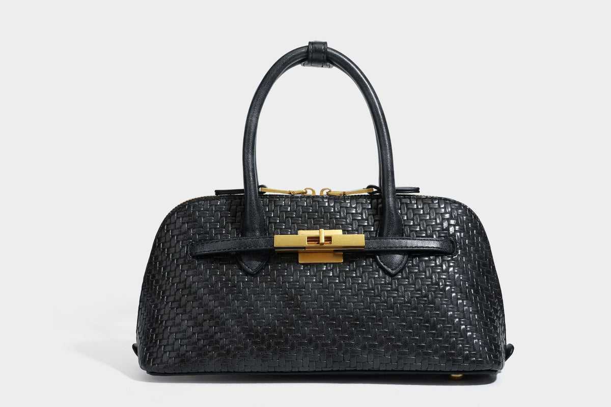 Structured woven-embossed leather-look satchel with dual rolled top handles, gold-tone turn-lock closure, and detachable