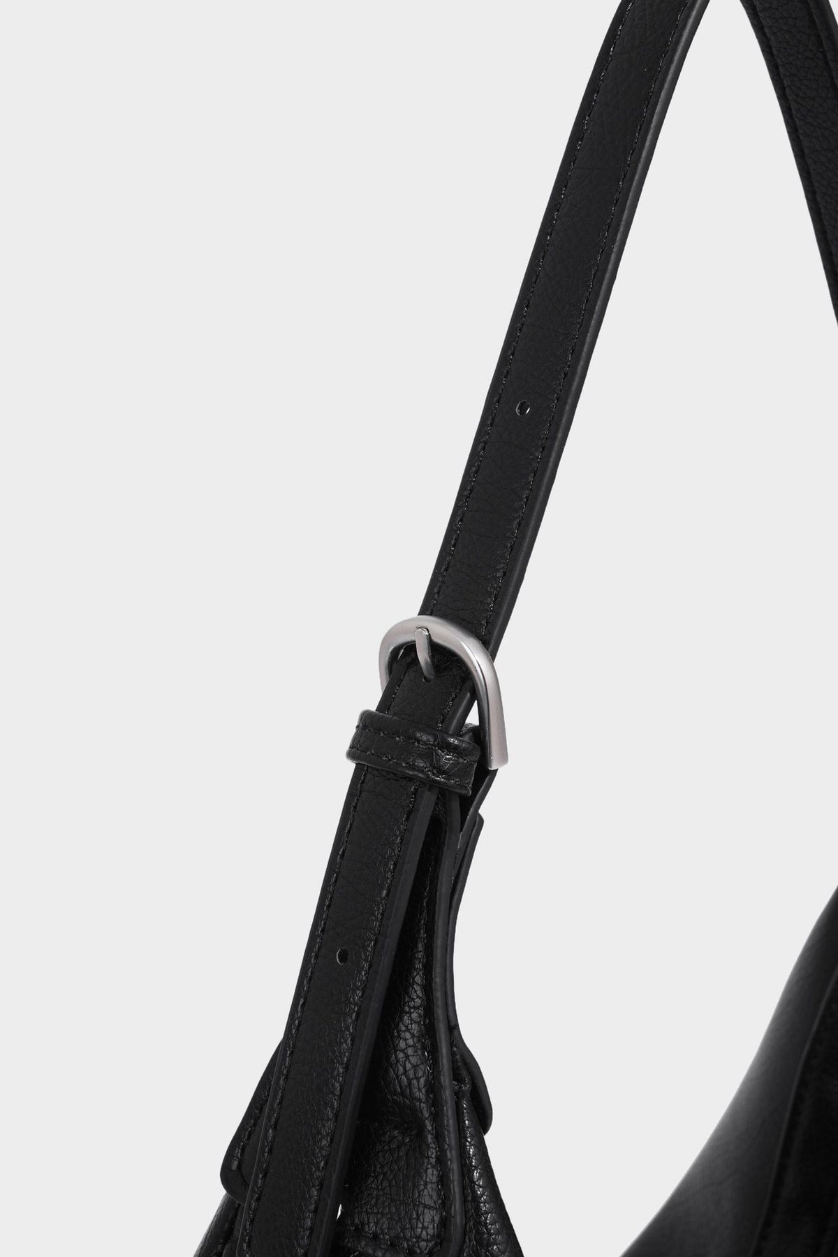 Crescent half-moon shoulder bag in pebbled leather-look finish with adjustable strap and silver-tone hardware, detail view 23