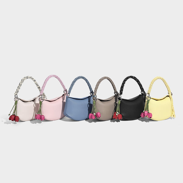 Small crescent half-moon bag in pebbled leather-look finish with braided top handle, silver-tone ring hardware, and, detail