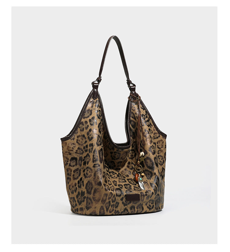 Large slouchy leopard-print shoulder tote bag with glossy tan-and-brown finish, dark brown leather-look trim, single