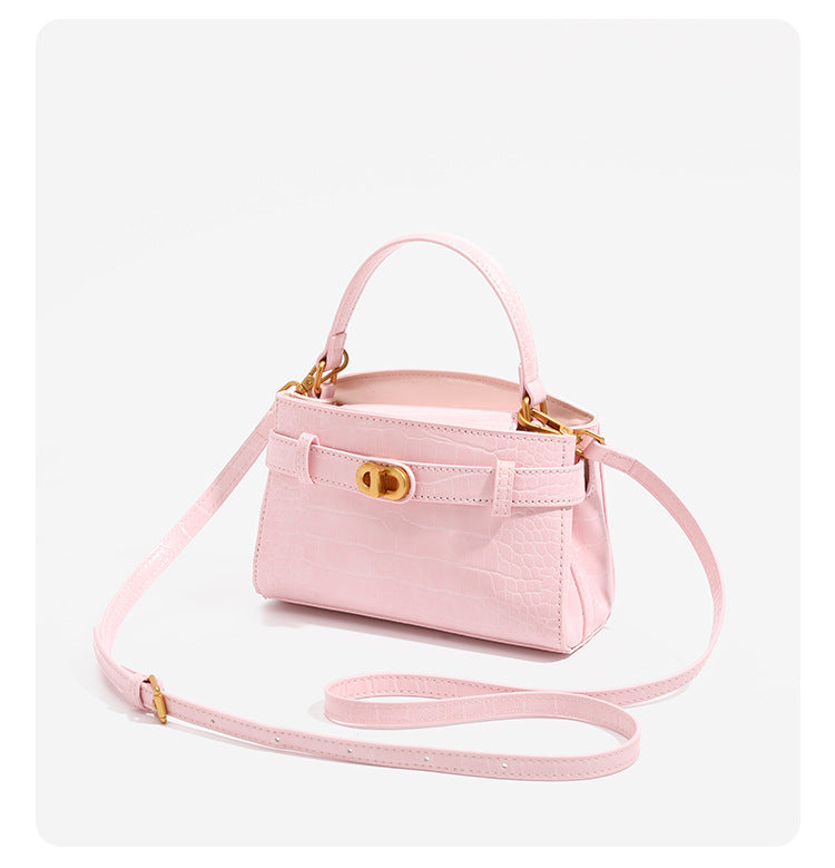 Small structured crocodile-embossed top-handle bag with gold-tone turn-lock closure and detachable shoulder strap, detail